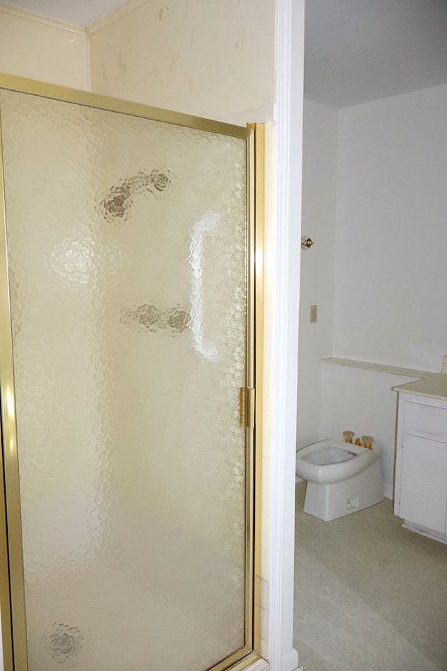 bathroom with a bidet and a shower with shower door