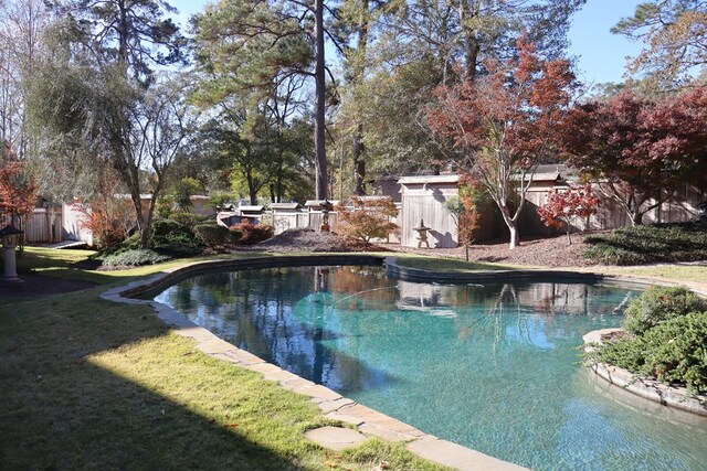 view of pool with a lawn