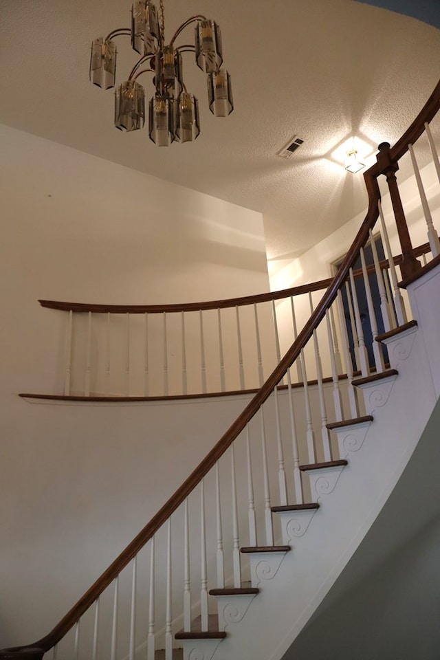 stairway with a textured ceiling