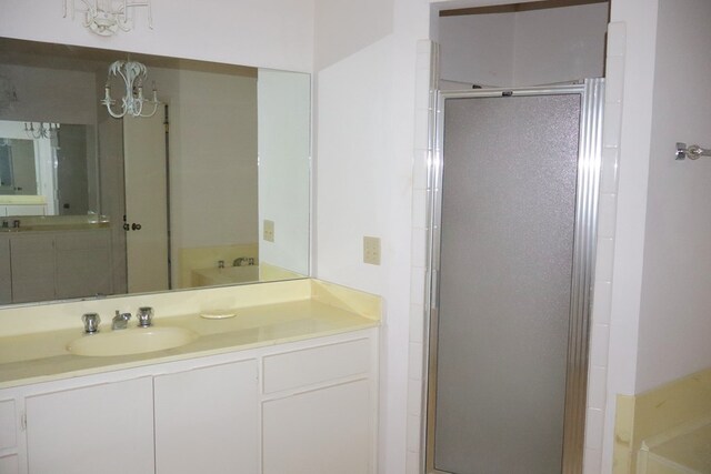 bathroom featuring vanity and an enclosed shower