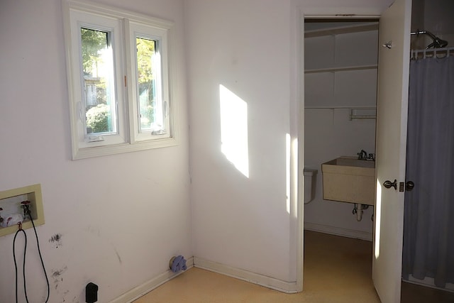 clothes washing area featuring washer hookup and sink