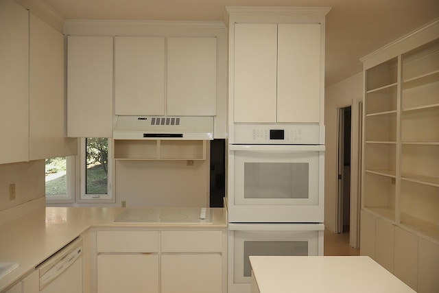 kitchen featuring white cabinets and white appliances