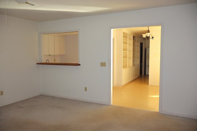 unfurnished room featuring an inviting chandelier