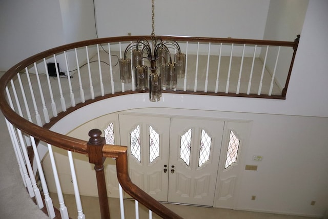 foyer with french doors and a notable chandelier