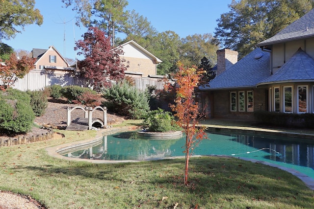 view of swimming pool with a yard