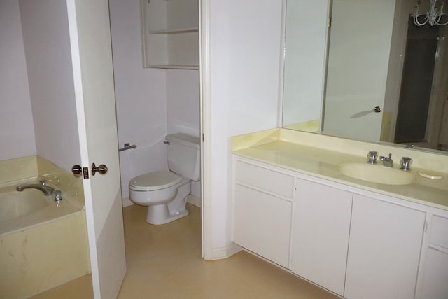 bathroom featuring vanity, toilet, and a tub