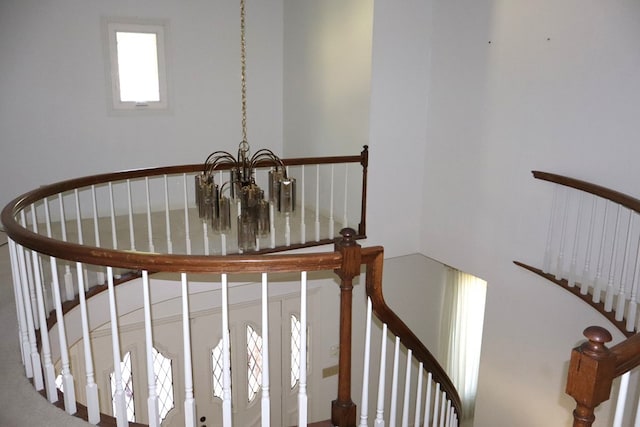 stairs featuring a notable chandelier