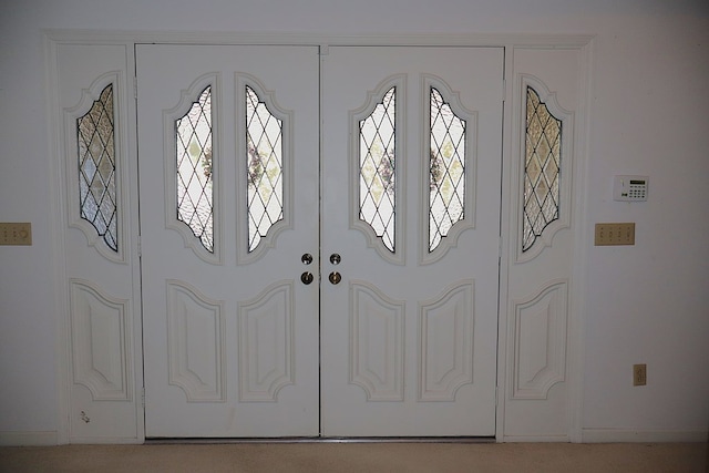 view of carpeted foyer entrance