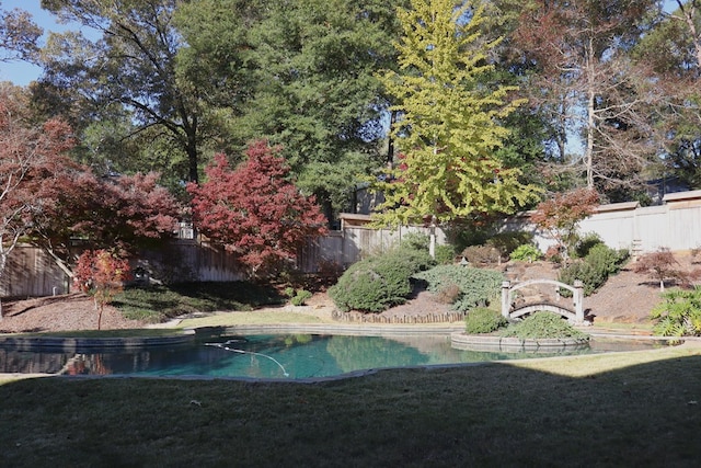 view of pool featuring a yard