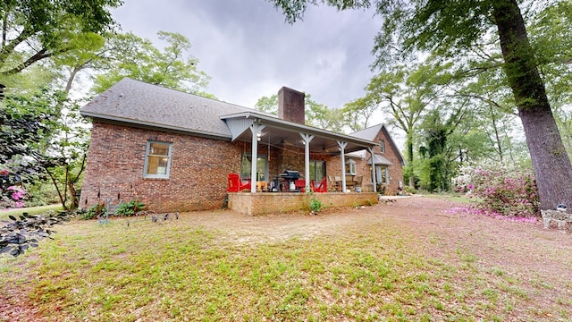 1109 Sanitary Dairy Rd, Cowarts, AL 36321 - back of house with brick siding, a yard, and a chimney