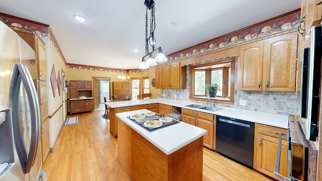 1109 Sanitary Dairy Rd, Cowarts, AL 36321 - kitchen featuring light countertops, a sink, light wood-style floors, a peninsula, and appliances with stainless steel finishes