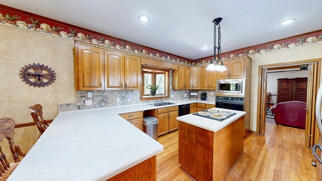 1109 Sanitary Dairy Rd, Cowarts, AL 36321 - kitchen with light countertops, a center island, a sink, light wood finished floors, and black appliances