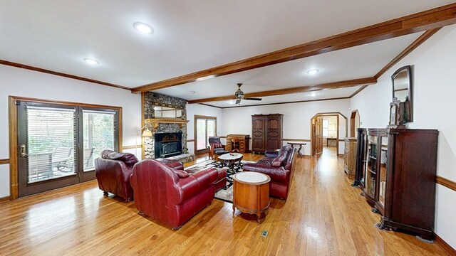 1109 Sanitary Dairy Rd, Cowarts, AL 36321 - living room with beam ceiling, a ceiling fan, a stone fireplace, light wood-type flooring, and ornamental molding