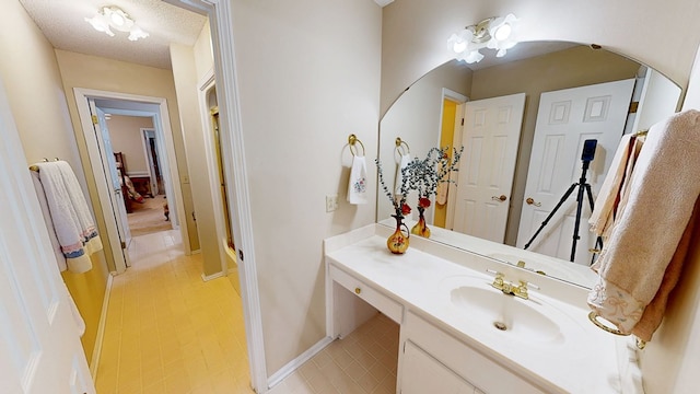 1109 Sanitary Dairy Rd, Cowarts, AL 36321 - bathroom with baseboards, vanity, and a textured ceiling