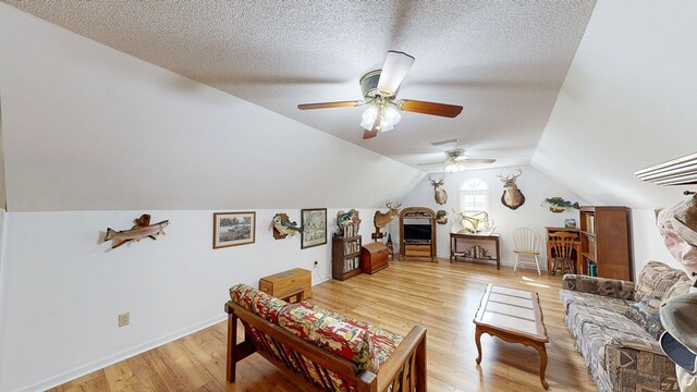 1109 Sanitary Dairy Rd, Cowarts, AL 36321 - living room featuring vaulted ceiling, baseboards, a textured ceiling, ceiling fan, and light wood-style flooring