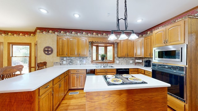 1109 Sanitary Dairy Rd, Cowarts, AL 36321 - kitchen with light countertops, a sink, a peninsula, visible vents, and black appliances