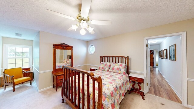 1109 Sanitary Dairy Rd, Cowarts, AL 36321 - bedroom with light carpet, baseboards, ceiling fan, and a textured ceiling