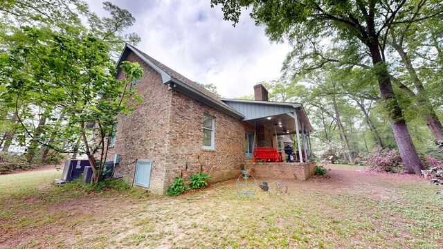 1109 Sanitary Dairy Rd, Cowarts, AL 36321 - view of side of property featuring a ceiling fan, brick siding, and a chimney