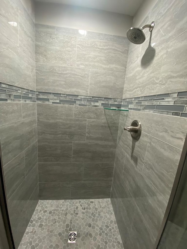 bathroom with tiled shower