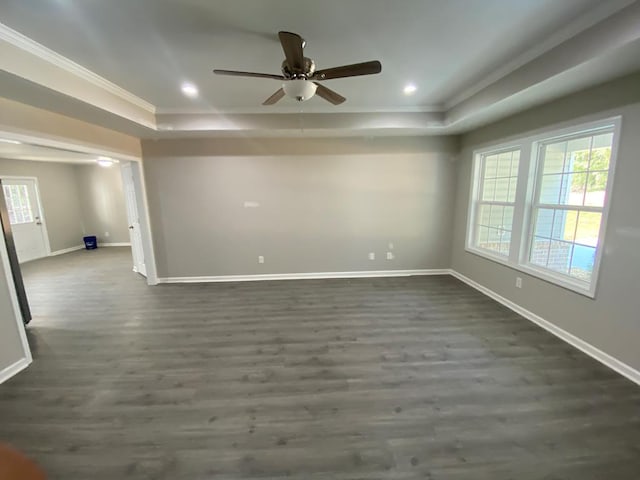 empty room featuring dark wood-type flooring, ceiling fan, and ornamental molding