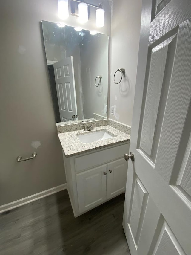 bathroom with vanity and hardwood / wood-style flooring