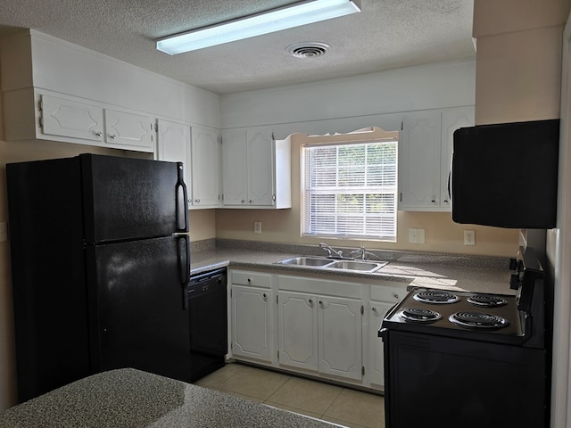 kitchen featuring light countertops, visible vents, white cabinets, a sink, and black appliances