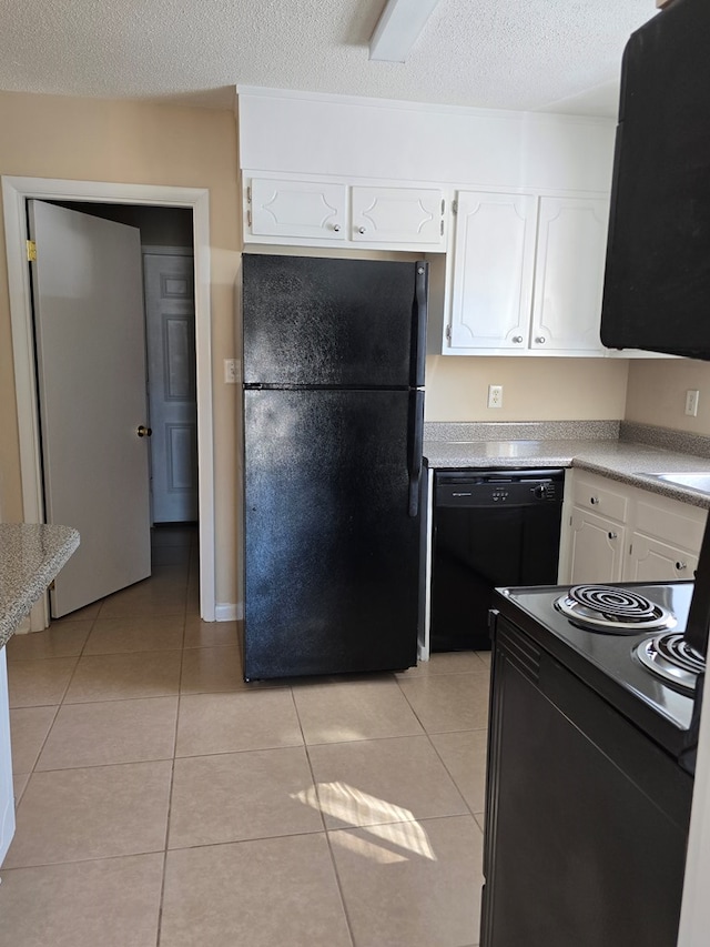 kitchen with light tile patterned floors, black appliances, light countertops, and white cabinets