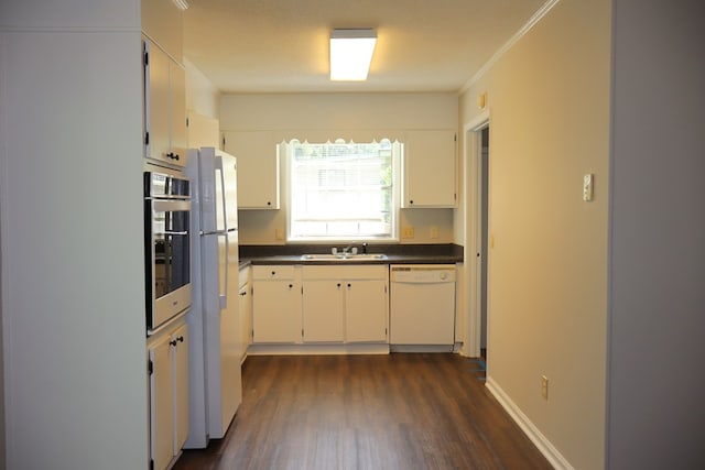 kitchen with ornamental molding, white appliances, sink, white cabinets, and dark hardwood / wood-style floors