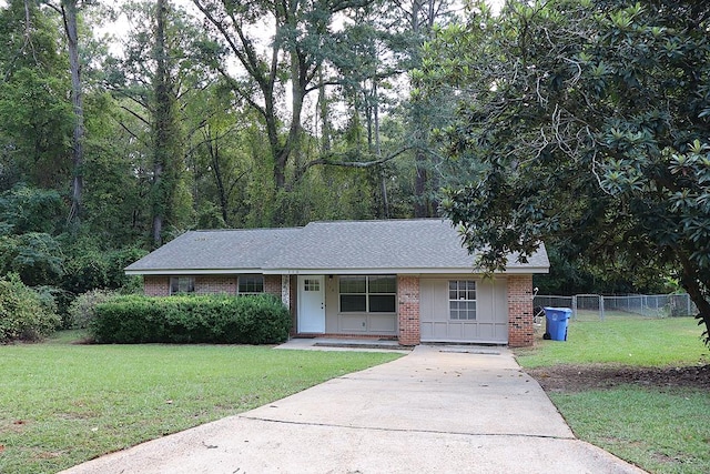 ranch-style house featuring covered porch and a front lawn