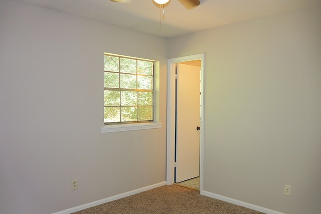 carpeted empty room featuring ceiling fan