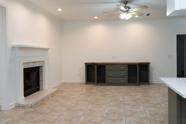 unfurnished living room with crown molding, ceiling fan, a fireplace, and light tile patterned flooring