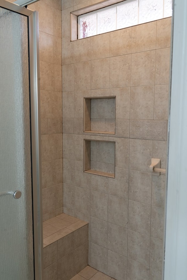 bathroom featuring a shower with shower door