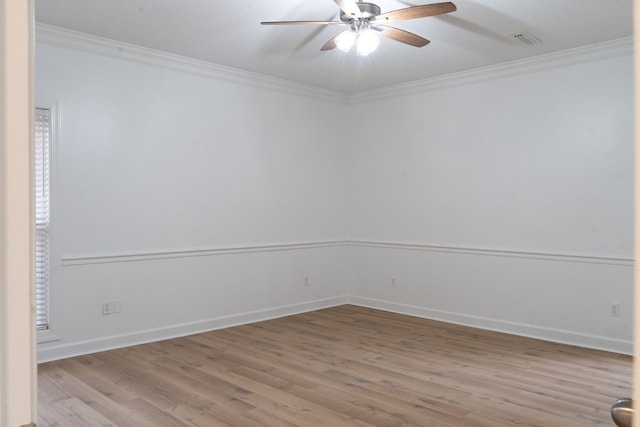 empty room with ceiling fan, ornamental molding, and light hardwood / wood-style flooring