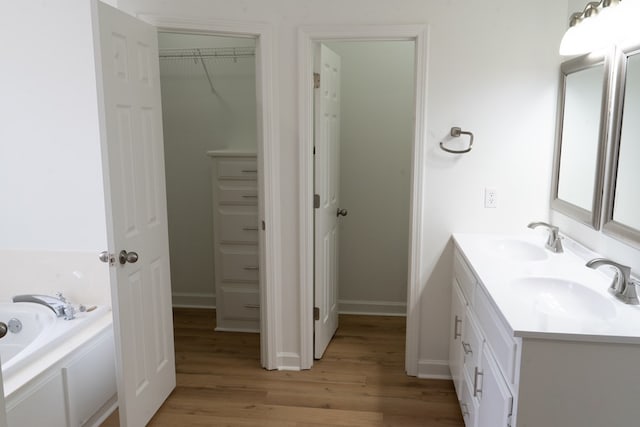 bathroom with vanity, hardwood / wood-style flooring, and a bathing tub