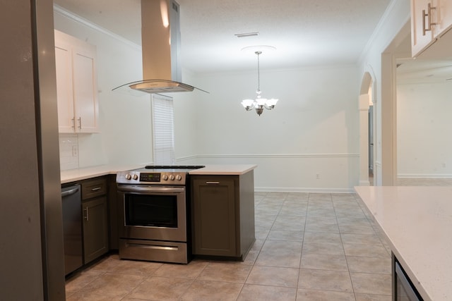 kitchen featuring crown molding, island range hood, hanging light fixtures, light tile patterned floors, and stainless steel appliances