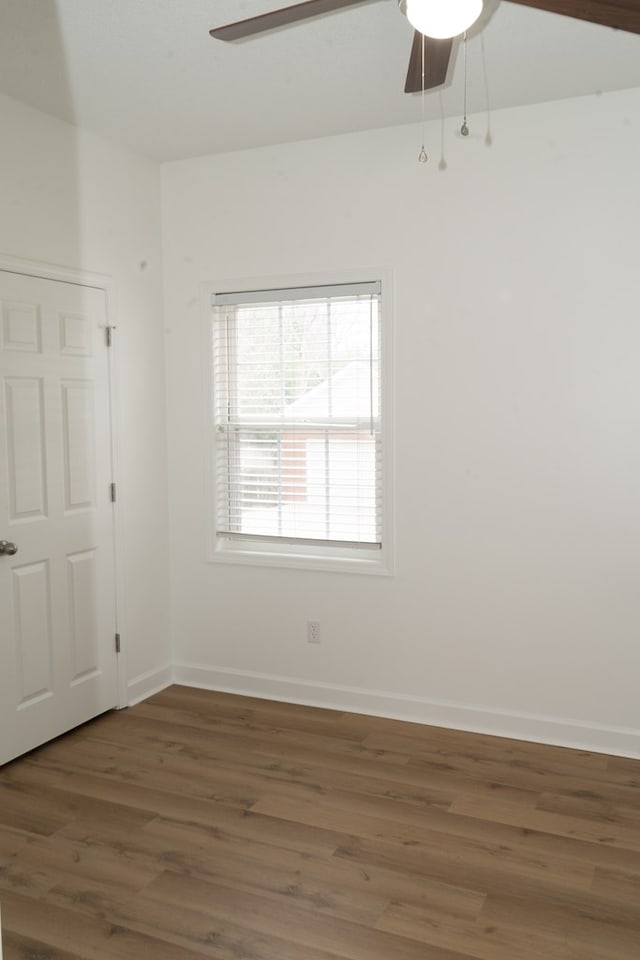 unfurnished room featuring dark hardwood / wood-style floors and ceiling fan