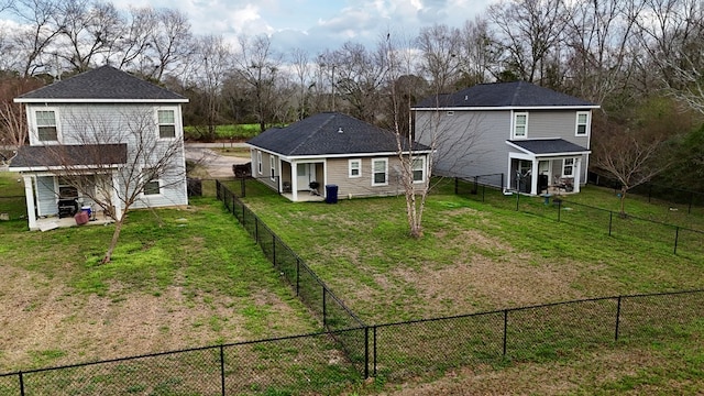 rear view of house featuring a yard and a patio