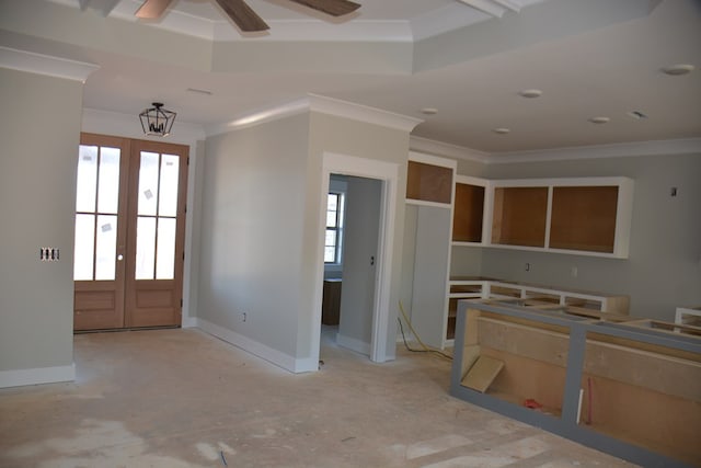 foyer entrance featuring plenty of natural light, ornamental molding, and french doors