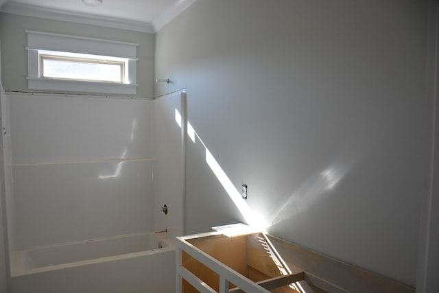 bathroom with crown molding and shower / washtub combination