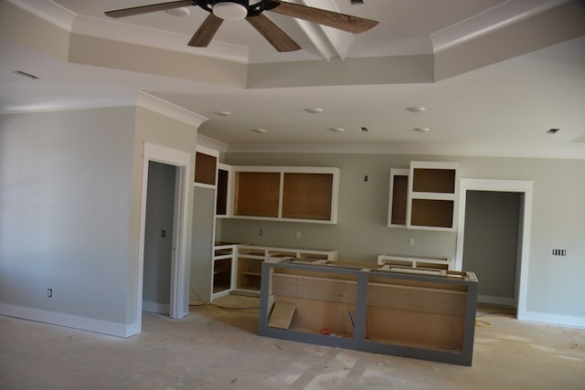 kitchen with ceiling fan, a raised ceiling, and ornamental molding