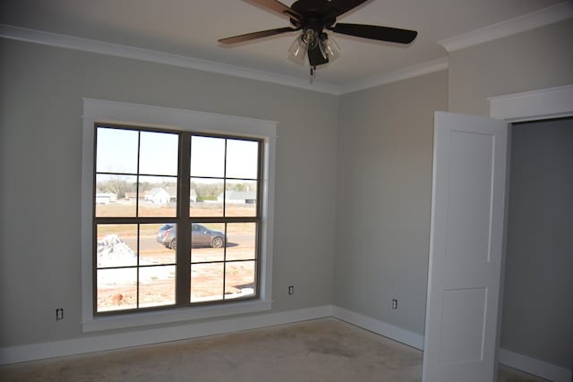 spare room featuring crown molding, plenty of natural light, and ceiling fan