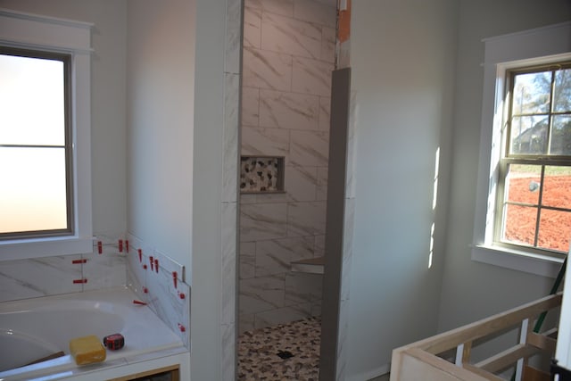 bathroom with separate shower and tub and plenty of natural light