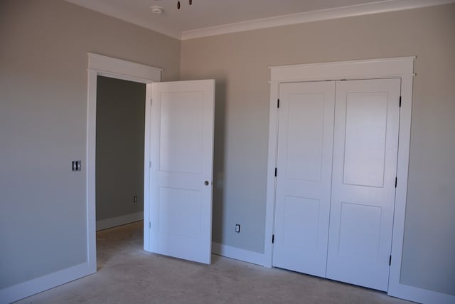 unfurnished bedroom featuring ornamental molding and a closet