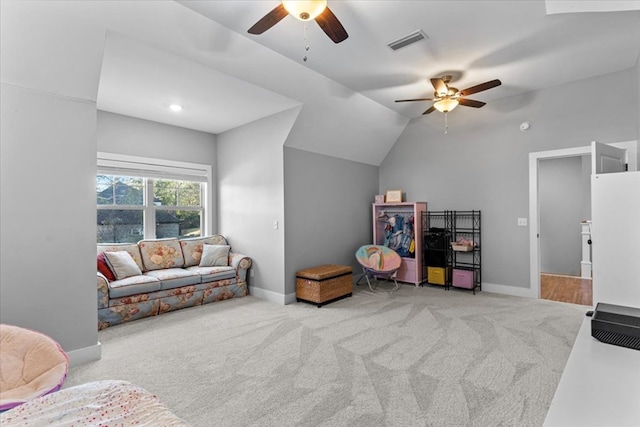 living room featuring ceiling fan, light colored carpet, and vaulted ceiling