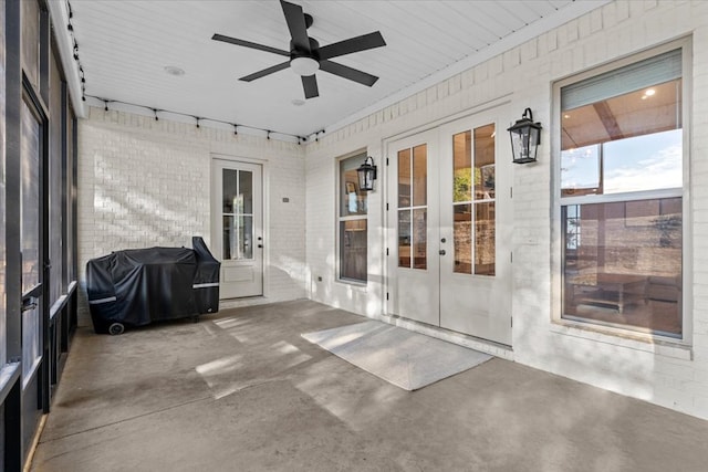 unfurnished sunroom with french doors and ceiling fan