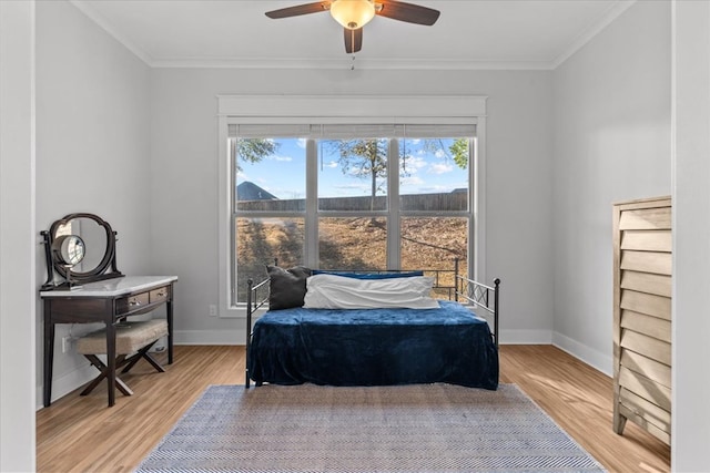 bedroom with wood-type flooring, ceiling fan, and ornamental molding