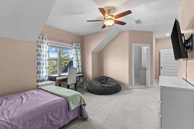 carpeted bedroom with ensuite bath and ceiling fan