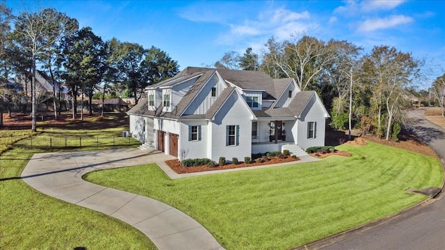 view of front facade featuring a front yard and a garage