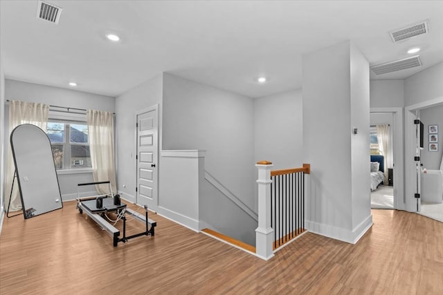 exercise area with light hardwood / wood-style flooring