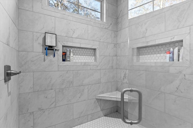 bathroom with plenty of natural light and a shower with door